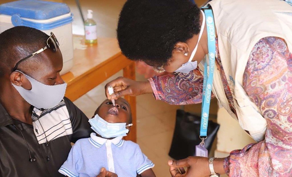 health workers vaccinating a child in Burkina Faso