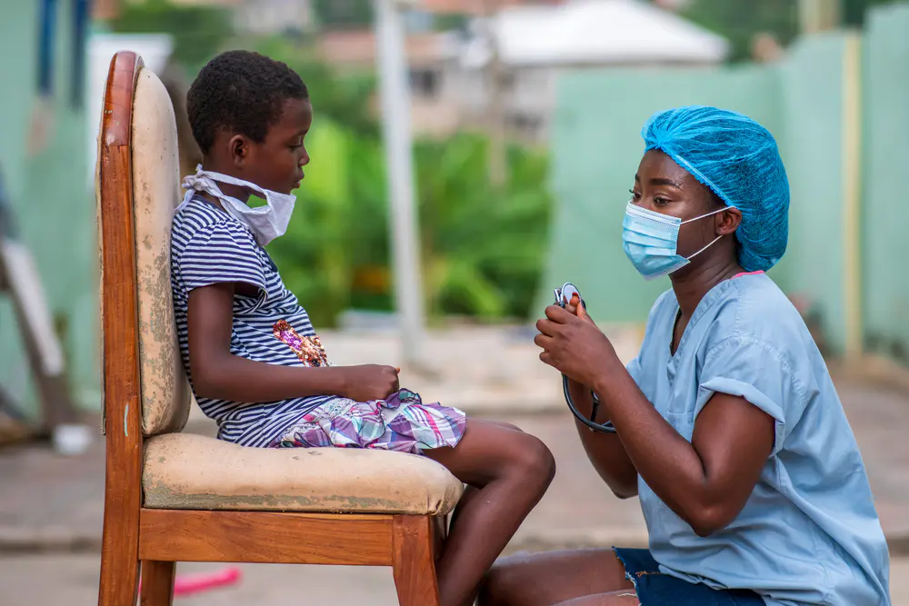 A healthcare worker attending to a child
