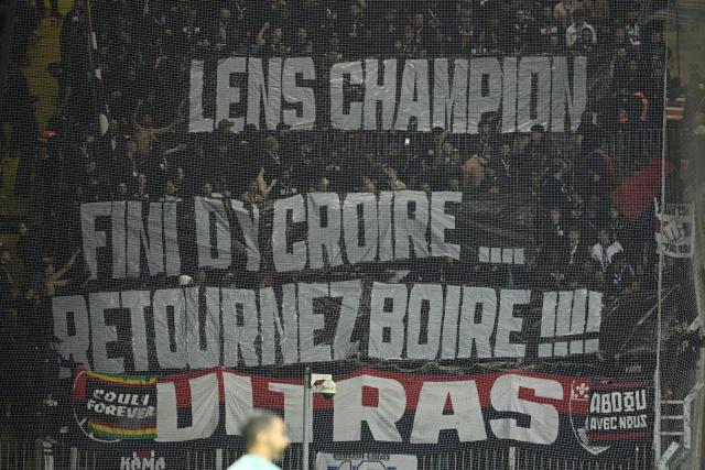 Paris sg’s title sparks fiery banner war at lens stadium