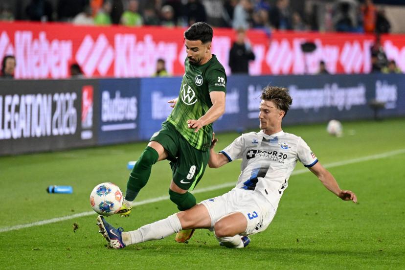Wolfsburg's Mohammed Amoura battles Paderborn's Jonah Sticker during the first leg of the Bundesliga promotion playoff