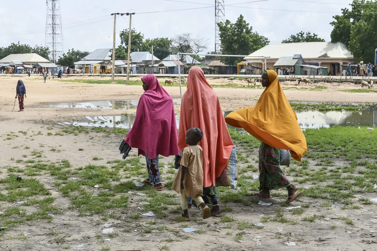 Survivors and relatives of victims of a suspected Boko Haram attack walk in Babban Gide on September 4, 2024. At least 81 people were killed and several remain missing after an assault by presumed Boko Haram jihadists in Yobe State, northeastern Nigeria.