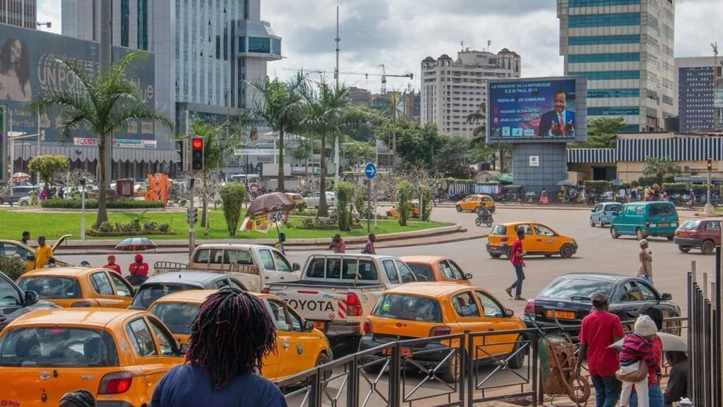 Taxi driver in Yaoundé checking digital registration details