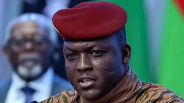 Close-up of Ibrahim Traoré in a beige military uniform and red beret