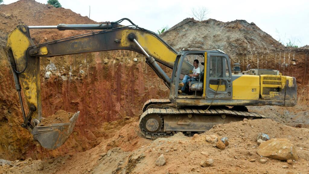 A Chinese mining company employee operates a bulldozer at an open-pit gold mine in Betare Oya, Cameroon, April 4, 2018.
